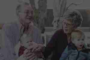 Elderly couple sitting with young children