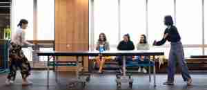 Girls is playing table tennis in free time at the office.