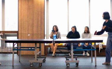 Girls is playing table tennis in free time at the office.