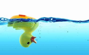 Rubber Duck upside down in water losing bubbles