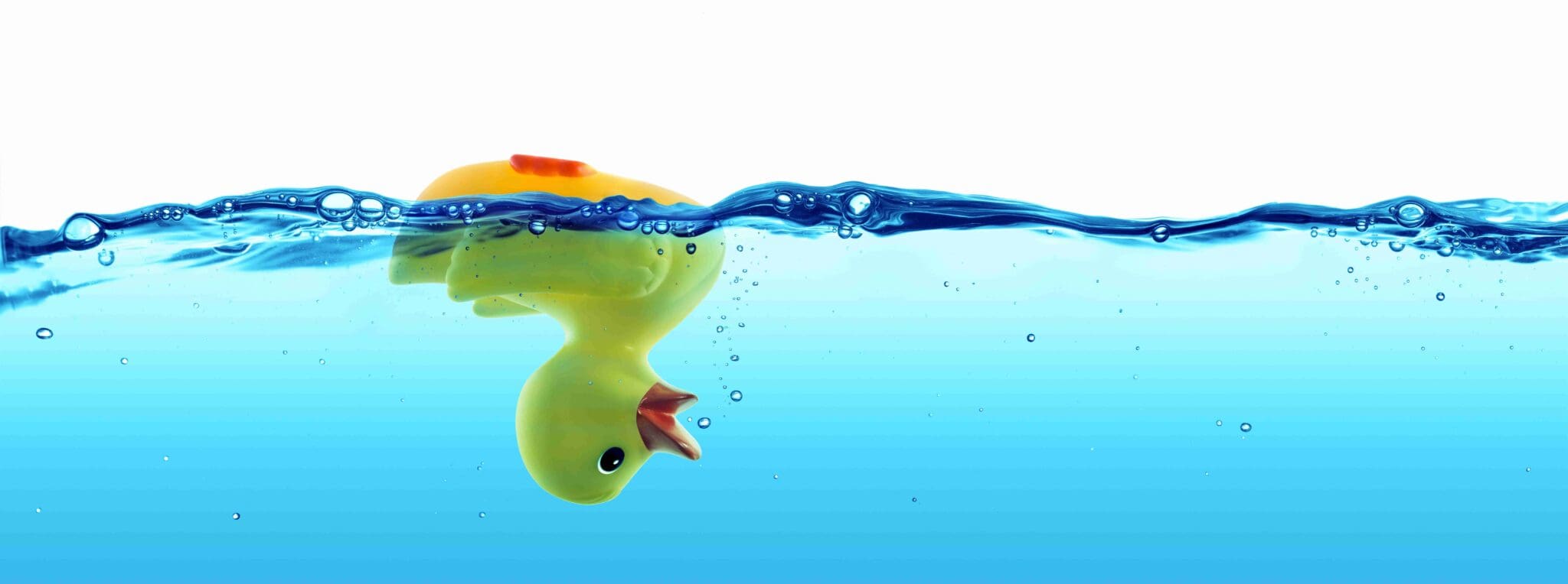 Rubber Duck upside down in water losing bubbles