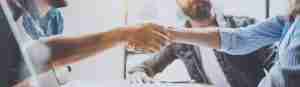 Business partnership handshake concept.Photo two coworkers handshaking process.Successful deal after great meeting.Horizontal, blurred background