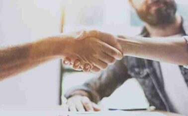 Business partnership handshake concept.Photo two coworkers handshaking process.Successful deal after great meeting.Horizontal, blurred background