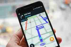 innovation in israel. image of a person holding an iphone with the waze application open. waze is a GPS navigation software app