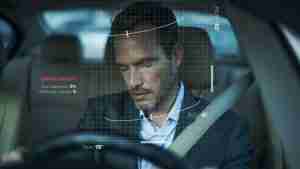 mobileye innovation in israel. image is of a man sleeping at a steering wheel of a car with mobileye's develops vision-based advanced driver-assistance systems