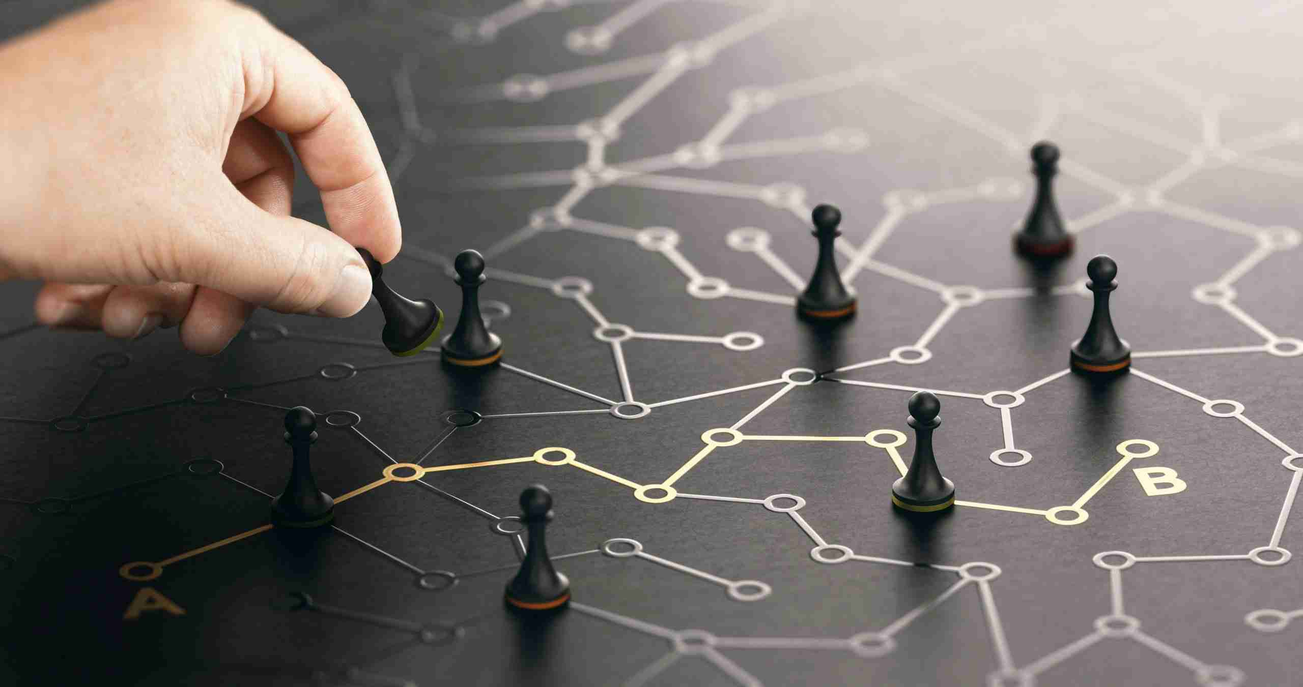 A picture of a person moving pieces on a post-modern chess board, representing the importance of strategic and long term thinking around customer experience.