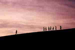People walking down a hill behind a leader representing innovation strategy