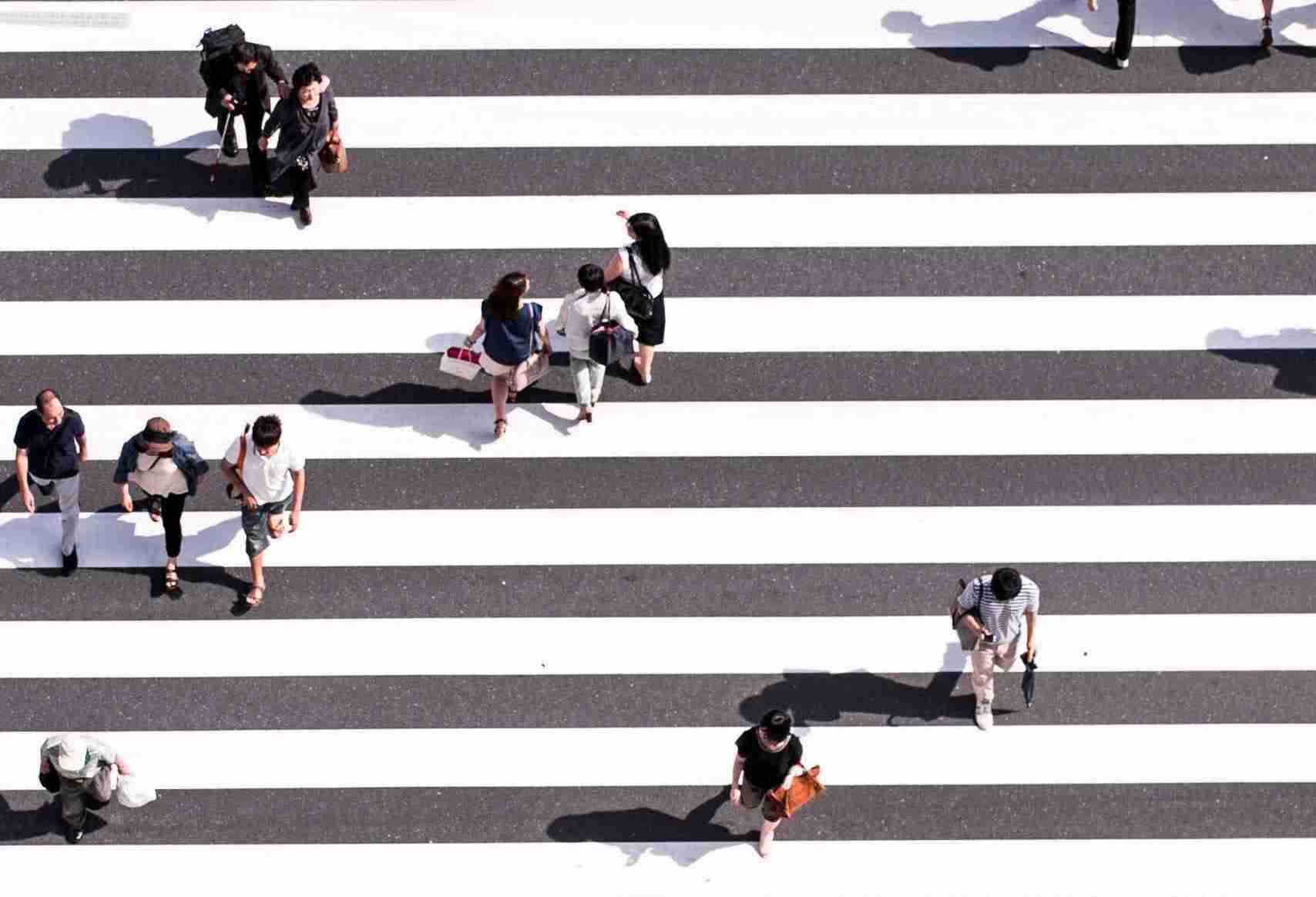 Birds eye view of pedestrians crossing at a road crossing representing Digital Strategy