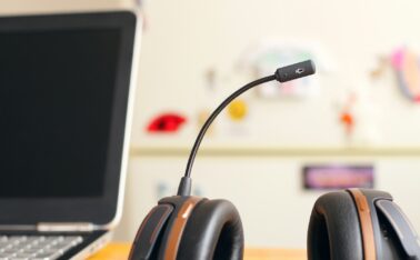 black and brown headset near laptop computer